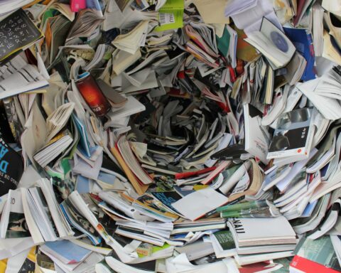 A whirlwind of books and papers creating a chaotic visual. Ideal for concepts of disorder or information overload.