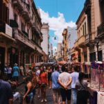 Bustling San Nicolas street market in Buenos Aires with stalls and crowds under a clear sky.