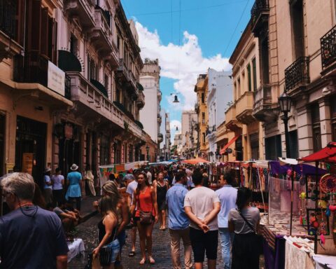 Bustling San Nicolas street market in Buenos Aires with stalls and crowds under a clear sky.